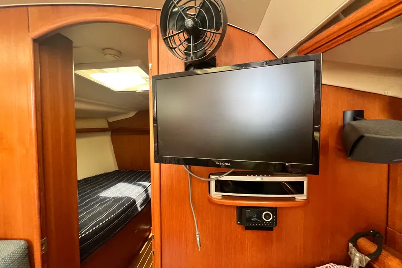 Slide: The Image of Interior of 2007 Hunter 41 Deck Salon with TV and fan setup. - 55