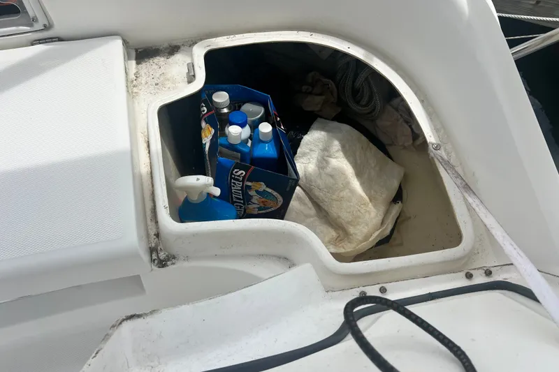 Slide: The Image of Storage compartment on a 2007 Hunter 41 Deck Salon yacht with cleaning supplies and ropes. - 13