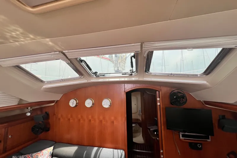 Slide: The Image of Interior of 2007 Hunter 41 Deck Salon with skylights, wood paneling, and instruments. - 50