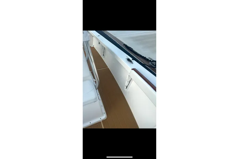 Slide: The Image of 2019 Albury Brothers 23 Forward Seating boat deck with sleek design and wood accents. - 21