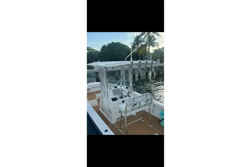 Slide: The Image of 2019 Albury Brothers 23 Forward Seating boat docked by the water, featuring sleek design. - 12