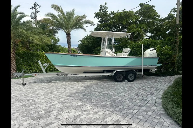Slide: The Image of 2019 Albury Brothers 23 Forward Seating boat on trailer, parked in tropical driveway. - 30
