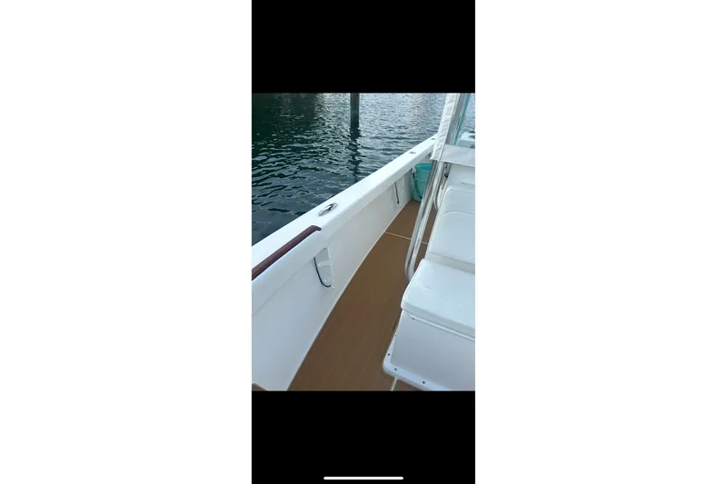 Slide: The Image of 2019 Albury Brothers 23 Forward Seating boat, featuring sleek white seating and teak-style flooring. - 22