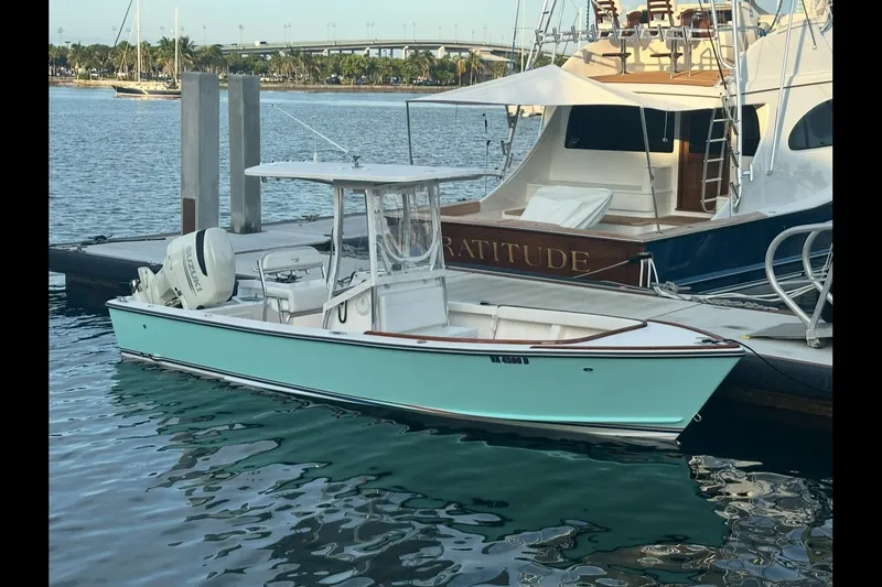 Slide: The Image of 2019 Albury Brothers 23 Forward Seating boat docked beside larger yacht. - 4