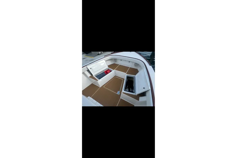 Slide: The Image of 2019 Albury Brothers 23 Forward Seating boat interior with storage compartments open. - 16
