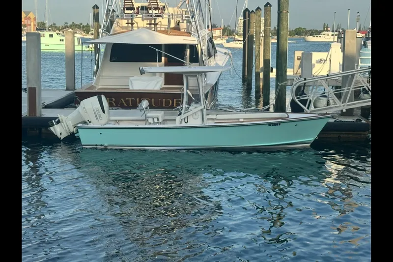 The Image of 2019 Albury Brothers 23 Forward Seating boat docked in a marina, turquoise hull. - 3