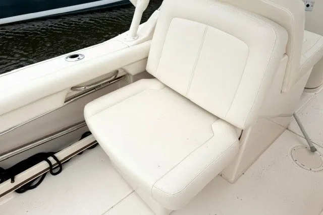 Slide: The Image of 2023 Grady-White Freedom 255 boat interior with white cushioned seating. - 15