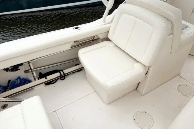 Slide: The Image of 2023 Grady-White Freedom 255 boat interior with white seating and storage. - 13