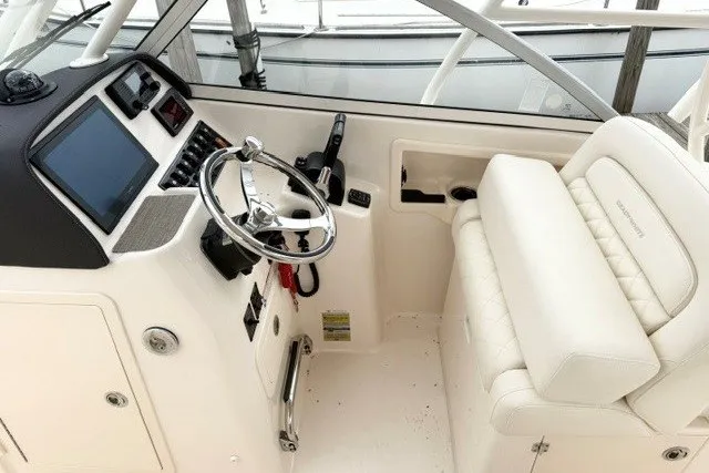 Slide: The Image of 2023 Grady-White Freedom 255 boat interior with steering wheel and seating. - 17