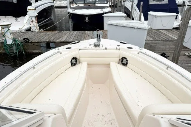 Slide: The Image of 2023 Grady-White Freedom 255 boat interior at marina, featuring spacious seating and modern design. - 21