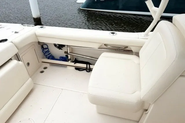 Slide: The Image of 2023 Grady-White Freedom 255 boat interior with white seating and storage compartments. - 14