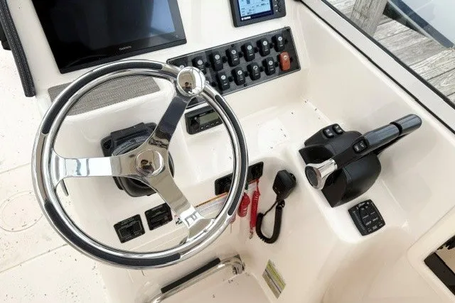 Slide: The Image of Helm of 2023 Grady-White Freedom 255 boat with steering wheel and controls. - 20