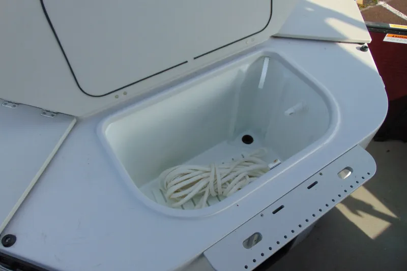 Slide: The Image of Open storage compartment on 2022 Godfrey Sweetwater 2186 FS boat with rope inside. - 19
