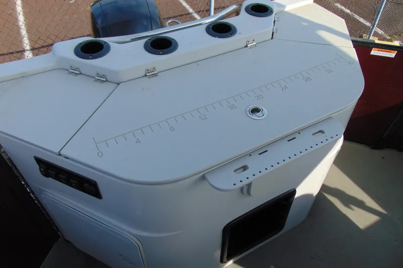 Slide: The Image of 2022 Godfrey Sweetwater 2186 FS boat console with cup holders and measurement markings. - 18