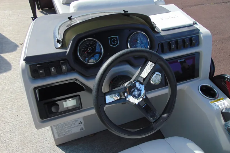 Slide: The Image of Steering console of 2022 Godfrey Sweetwater 2186 FS boat with gauges and controls. - 12