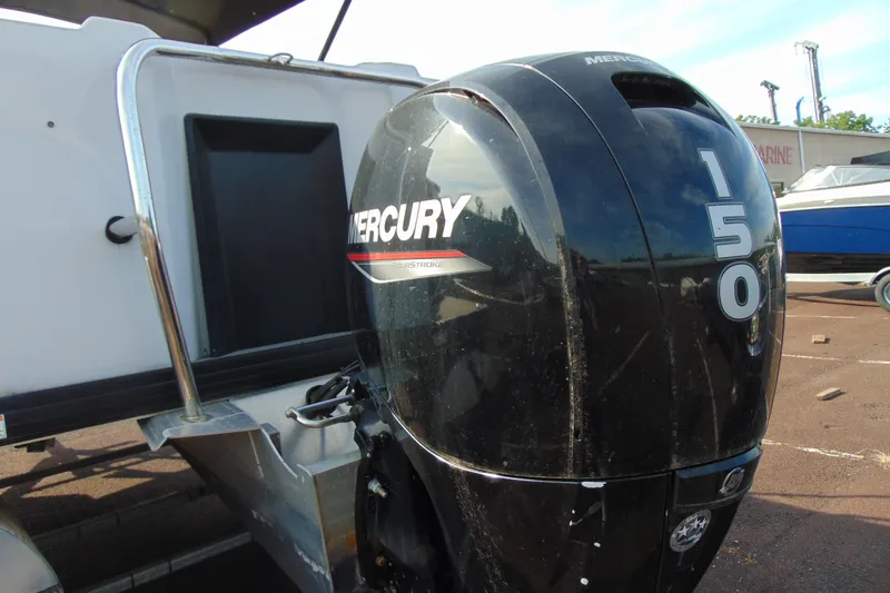 Slide: The Image of 2022 Godfrey Sweetwater 2186 FS with Mercury 150 outboard motor, parked on a sunny day. - 4