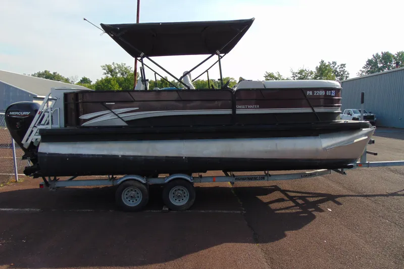 Slide: The Image of 2022 Godfrey Sweetwater 2186 FS pontoon boat on trailer, side view. - 6