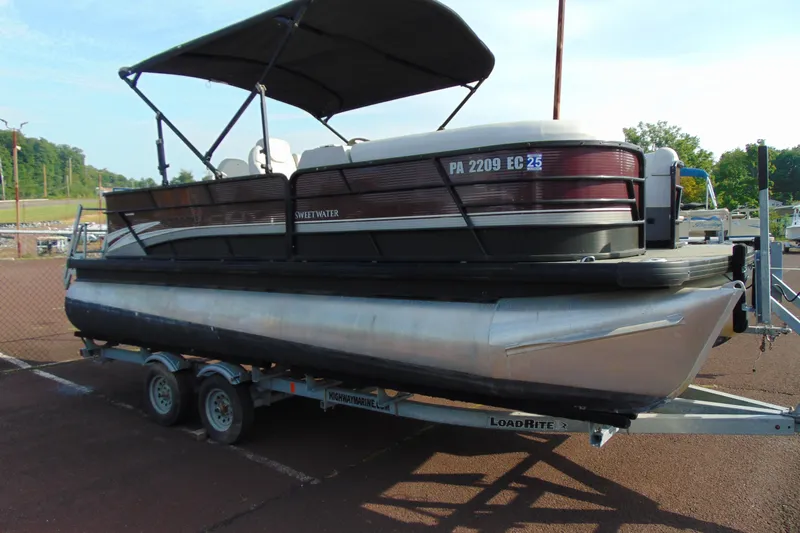 Slide: The Image of 2022 Godfrey Sweetwater 2186 FS pontoon boat on trailer, parked outdoors. - 1