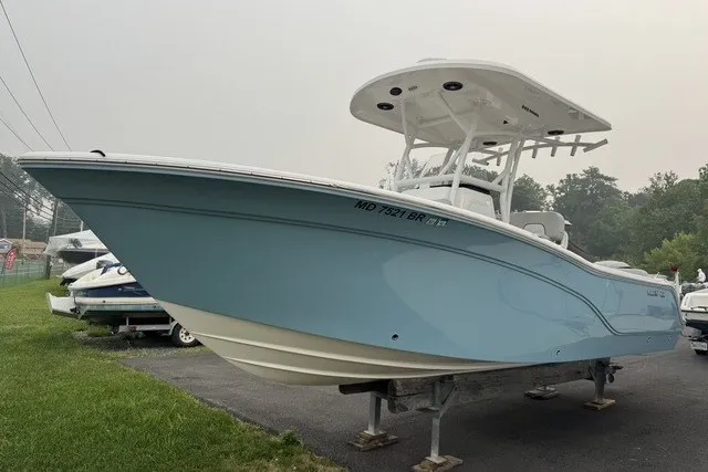 The Image of 2022 Sea Fox 249 Avenger boat in light blue, displayed on a stand outdoors. - 11