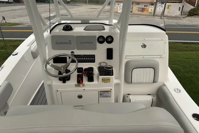 Slide: The Image of 2022 Sea Fox 249 Avenger boat dashboard with Garmin navigation systems and steering wheel. - 26