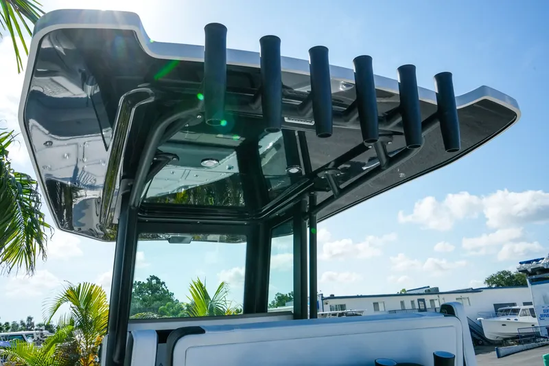 Slide: The Image of 2027 Blackfin 262 HB boat with sleek T-top and rod holders under sunny sky. - 15