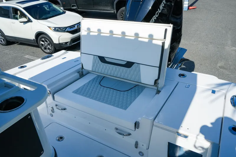 Slide: The Image of 2027 Blackfin 262 HB boat with foldable seating and storage, parked near a white SUV. - 29