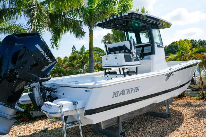 Slide: The Image of 2027 Blackfin 262 HB boat with Mercury engine, displayed outdoors among palm trees. - 3