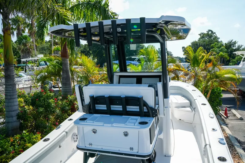Slide: The Image of 2027 Blackfin 262 HB boat with sleek design, surrounded by tropical foliage. - 9