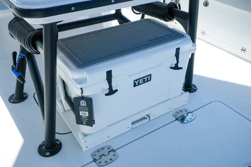 Slide: The Image of YETI cooler on 2027 Blackfin 262 HB boat deck, under a sturdy black frame. - 13