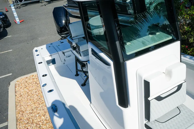 Slide: The Image of 2027 Blackfin 262 HB boat with sleek design and modern features, docked outdoors. - 26