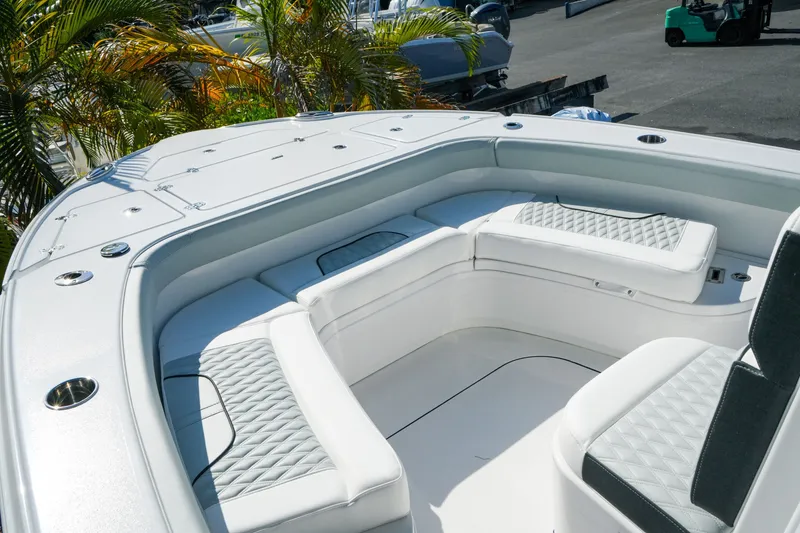 Slide: The Image of 2027 Blackfin 262 HB boat interior with white cushioned seating and sleek design. - 21