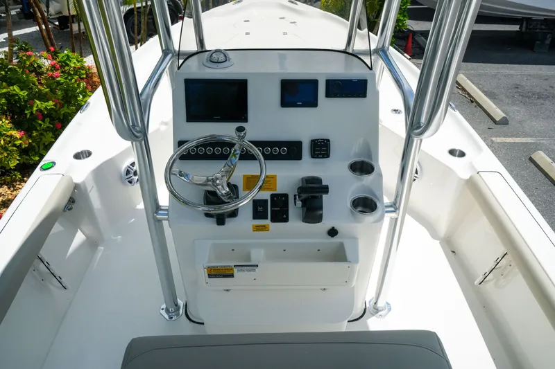 Slide: The Image of 2027 Key West 230 Bay Reef boat console with steering wheel and navigation controls. - 14