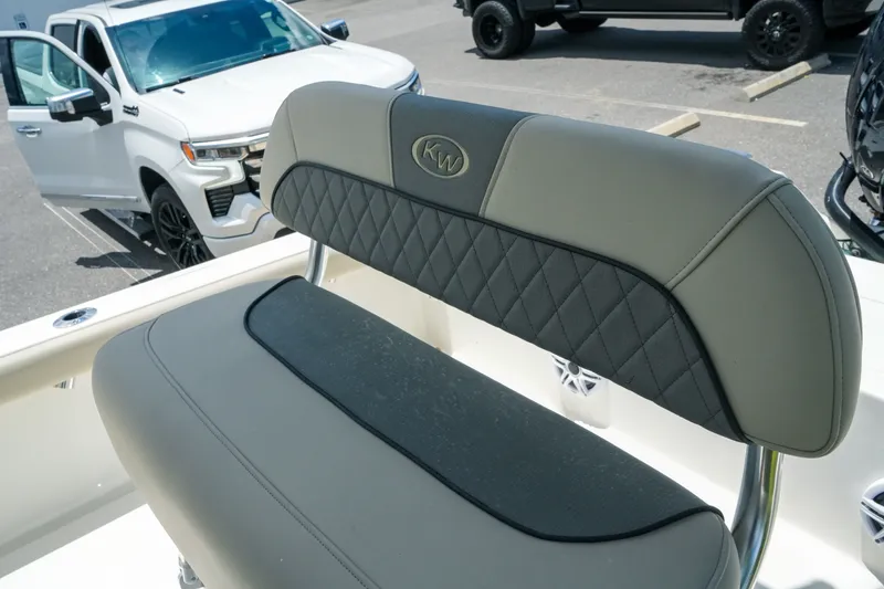 Slide: The Image of 2027 Key West 230 Bay Reef boat seat with diamond stitching, parked white SUV in background. - 29