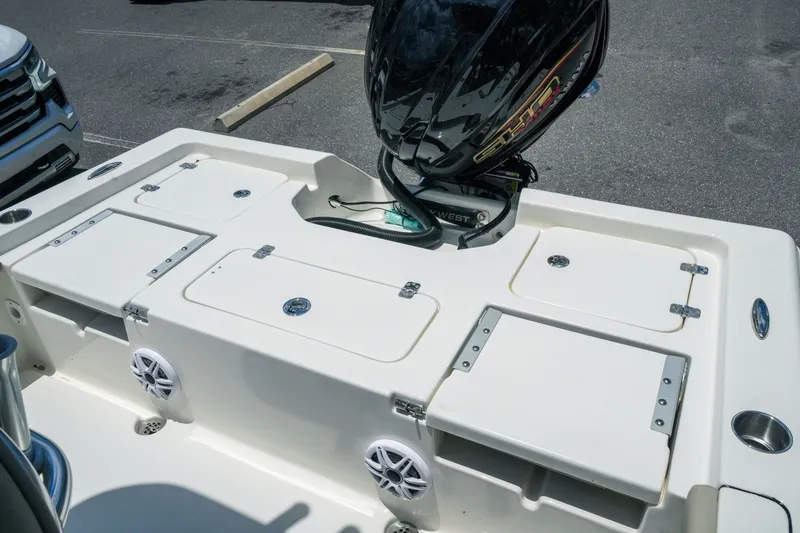 Slide: The Image of 2027 Key West 230 Bay Reef boat with motor, storage compartments, and speakers. - 30
