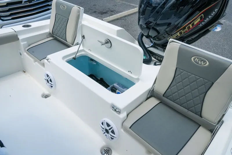 Slide: The Image of 2027 Key West 230 Bay Reef boat interior with seating and storage compartments. - 33
