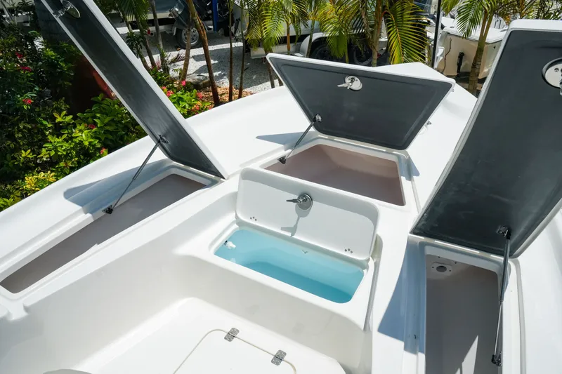 Slide: The Image of Open storage compartments on a 2027 Key West 230 Bay Reef boat deck. - 21