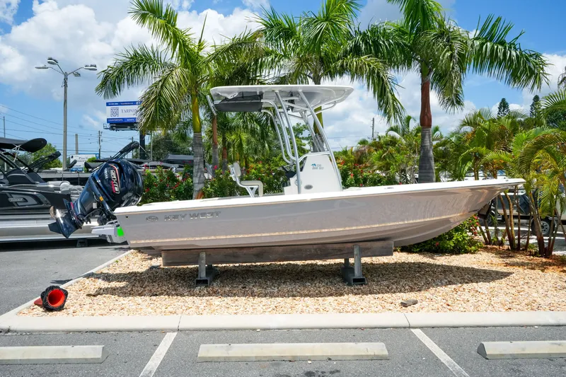 The Image of 2027 Key West 230 Bay Reef boat displayed outdoors with palm trees in the background. - 1