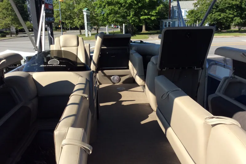 The Image of 2021 SUNTRAKER PARTY BARGE 20 DLX interior with beige seating and open layout. - 1