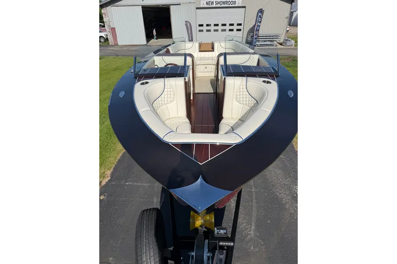 Slide: The Image of 2025 StanCraft 260 Day Boat with luxurious seating, showcased in a showroom setting. - 26
