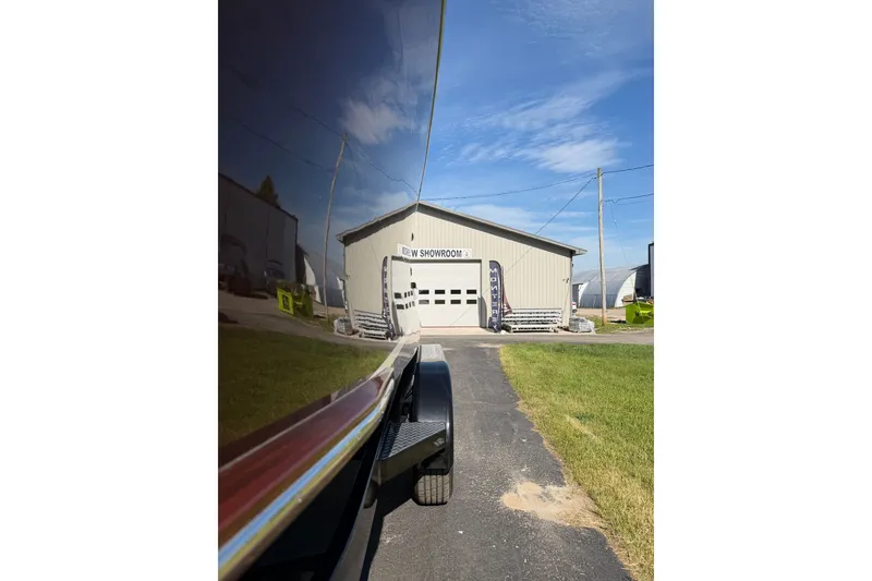 Slide: The Image of Reflection of StanCraft 260 Day Boat, 2025 model, outside a showroom under a clear sky. - 27