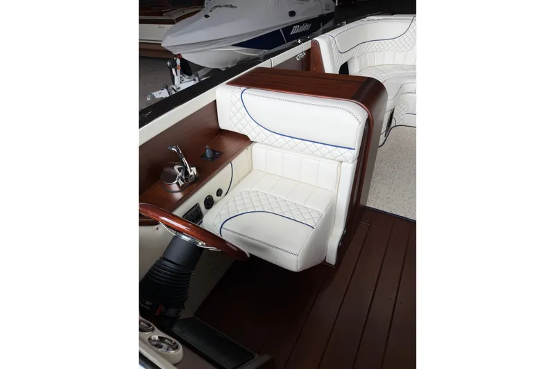 Slide: The Image of Luxurious interior of 2025 StanCraft 260 Day Boat with white leather seating and wooden accents. - 16
