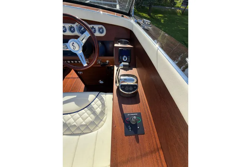 Slide: The Image of Interior of 2025 StanCraft 260 Day Boat with wooden dashboard and steering wheel. - 36