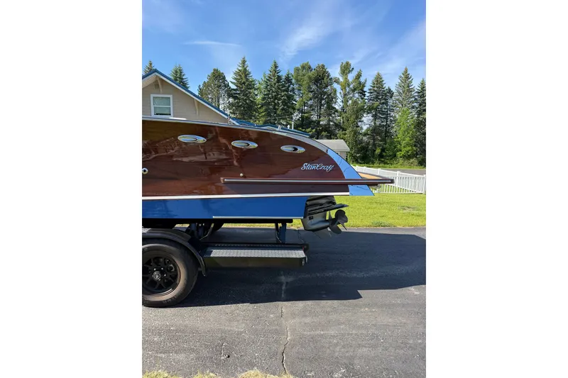 The Image of 2025 StanCraft 260 Day Boat on trailer, showcasing elegant wooden design and sleek lines. - 1