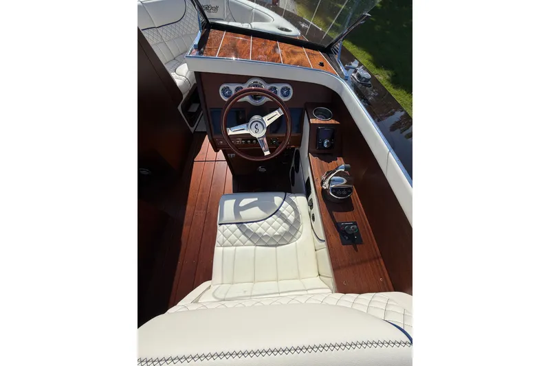Slide: The Image of 2025 StanCraft 260 Day Boat cockpit with luxurious leather seating and wooden dashboard. - 34