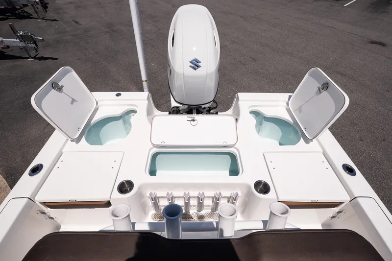Slide: The Image of 2027 Sea Pro 210 Bay boat deck with storage compartments and motor. - 17