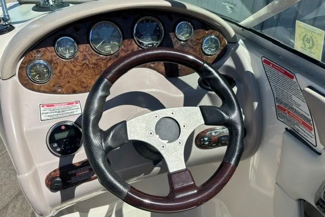 Slide: The Image of Steering wheel and dashboard of a 2004 Sea Ray 200 Sundeck boat. - 5