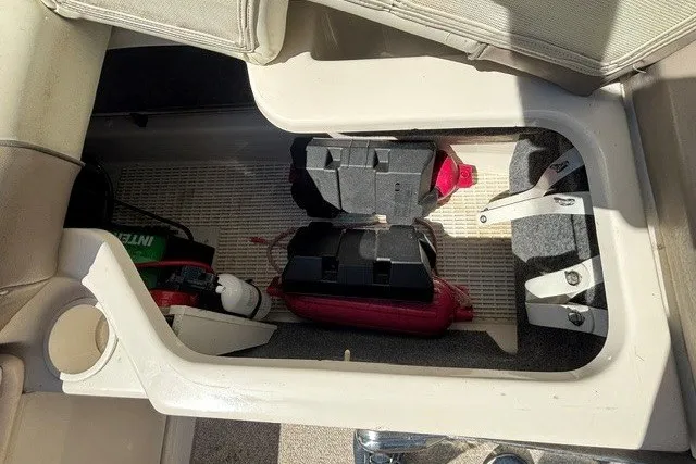 Slide: The Image of Storage compartment in a 2004 Sea Ray 200 Sundeck with various boating equipment. - 16