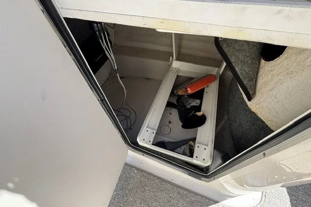 Slide: The Image of Storage compartment of a 2004 Sea Ray 200 Sundeck boat, showing interior details. - 18