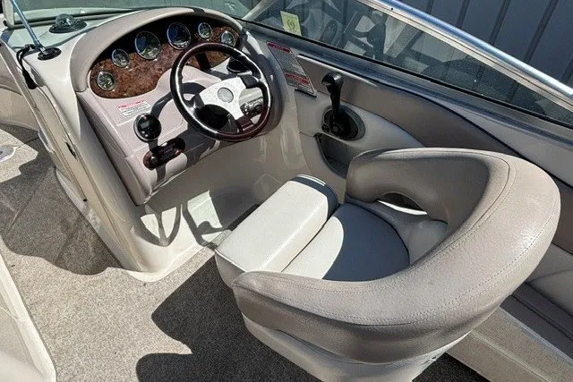 Slide: The Image of 2004 Sea Ray 200 Sundeck boat interior with steering wheel and dashboard controls. - 6