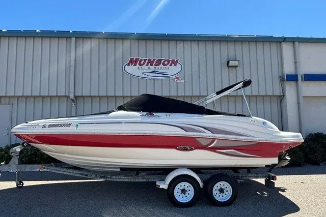 Slide: The Image of 2004 Sea Ray 200 Sundeck boat on trailer, parked outside Munson building. - 3